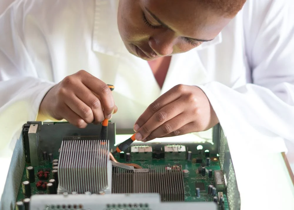 Female engineer working on computer motherboard