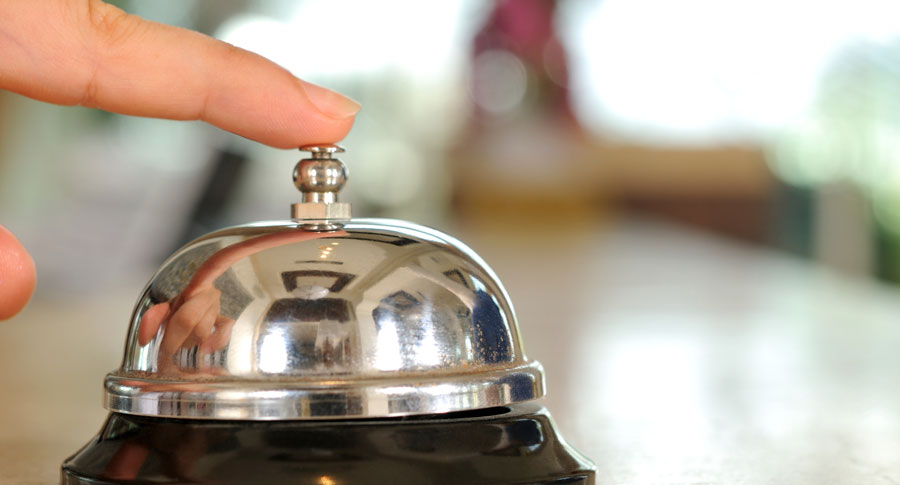 Finger poised on customer service bell